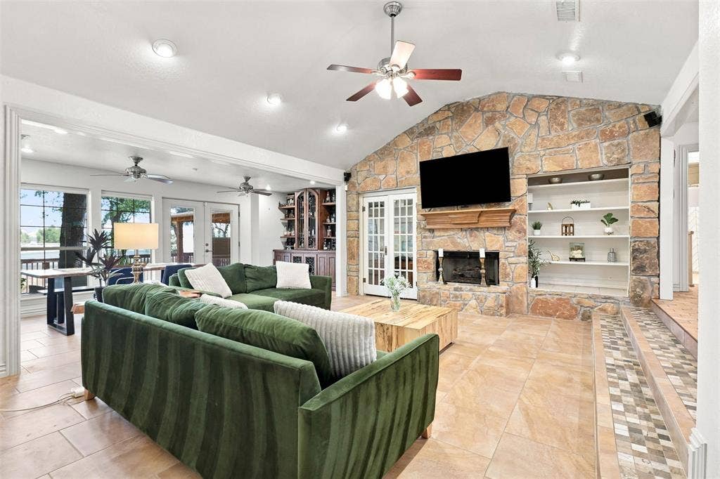 284 Shoreline Drive N, Azle, TX 76020 Stone accent wall with built-in shelving, fireplace, and wood mantel