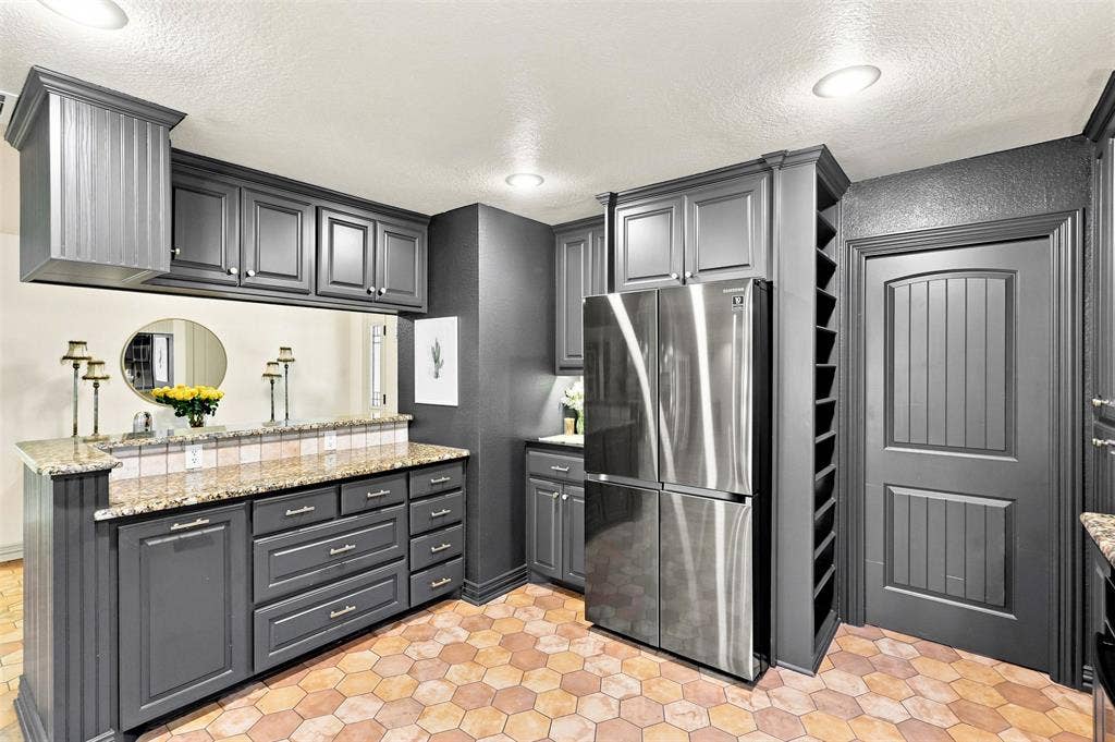 284 Shoreline Drive N, Azle, TX 76020 Hexagonal tile flooring, dark gray cabinetry, stainless steel refrigerator, built-in wine storage, and a paneled door