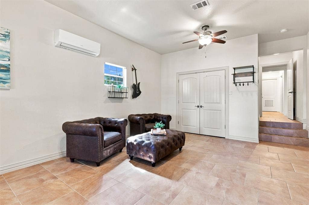 284 Shoreline Drive N, Azle, TX 76020 Tiled flooring, white walls, double panel doors, ceiling fan, and mini-split air conditioning unit