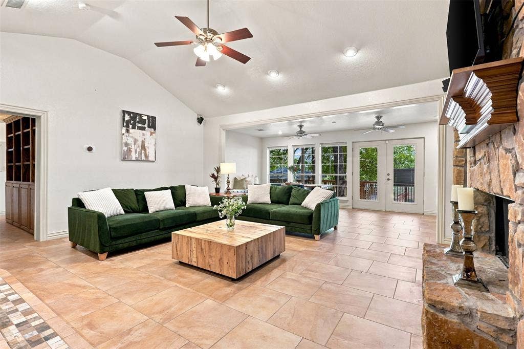 284 Shoreline Drive N, Azle, TX 76020 Vaulted ceiling with recessed lighting and ceiling fan, stone fireplace, and tile flooring