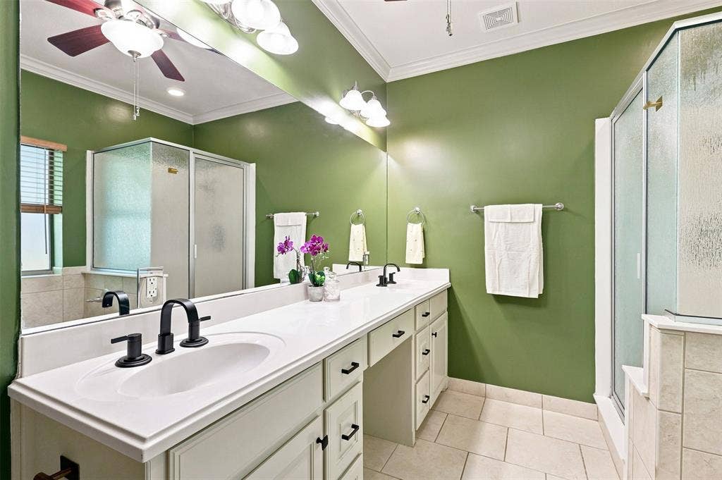 284 Shoreline Drive N, Azle, TX 76020 Dual vanity with white countertop and black fixtures, tiled flooring, built-in shower, and mirrored wall