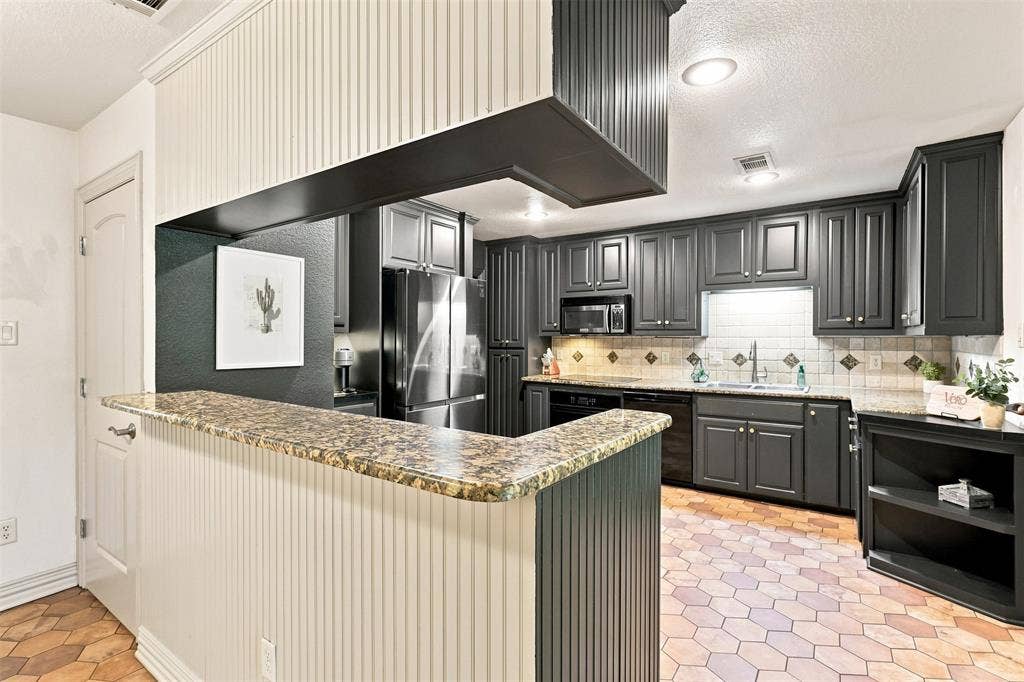 284 Shoreline Drive N, Azle, TX 76020 Kitchen featuring beautiful cabinetry, light-toned countertops, a stainless steel refrigerator, and a tiled backsplash