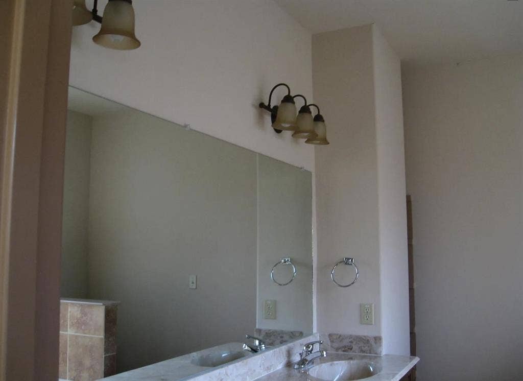 2514 Apollo Villa Road, Garland, TX 75044 Dual vanity with integrated sinks, polished chrome faucets, and stone countertop