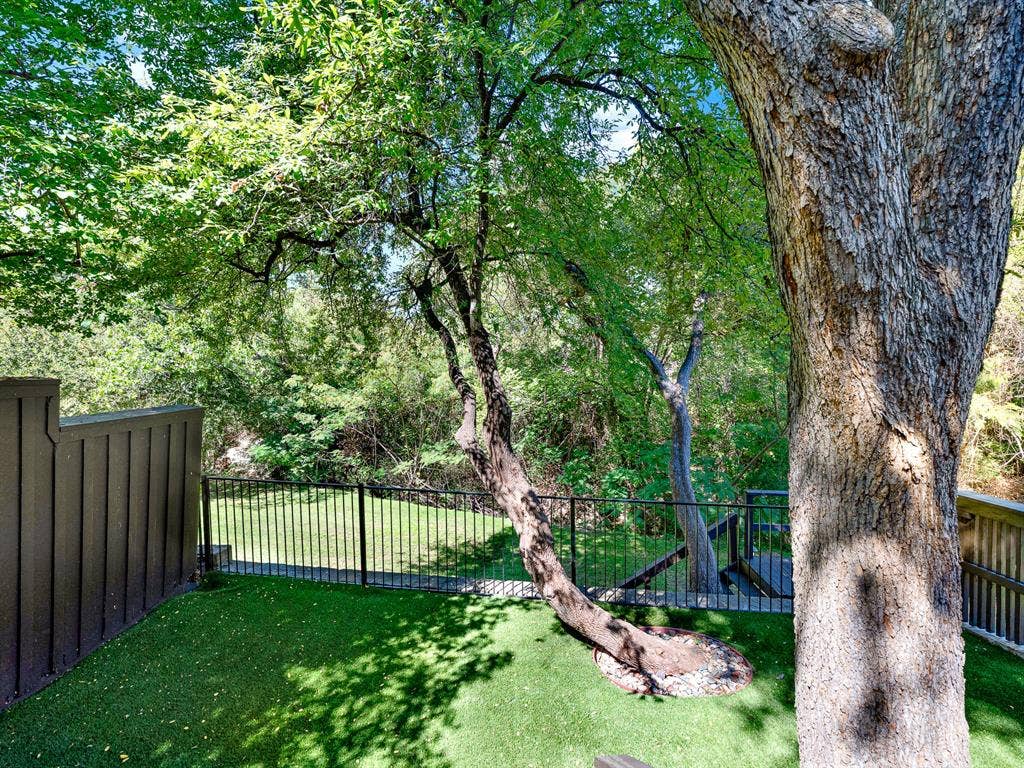 Backyard with Turf and Rod Iron Fence