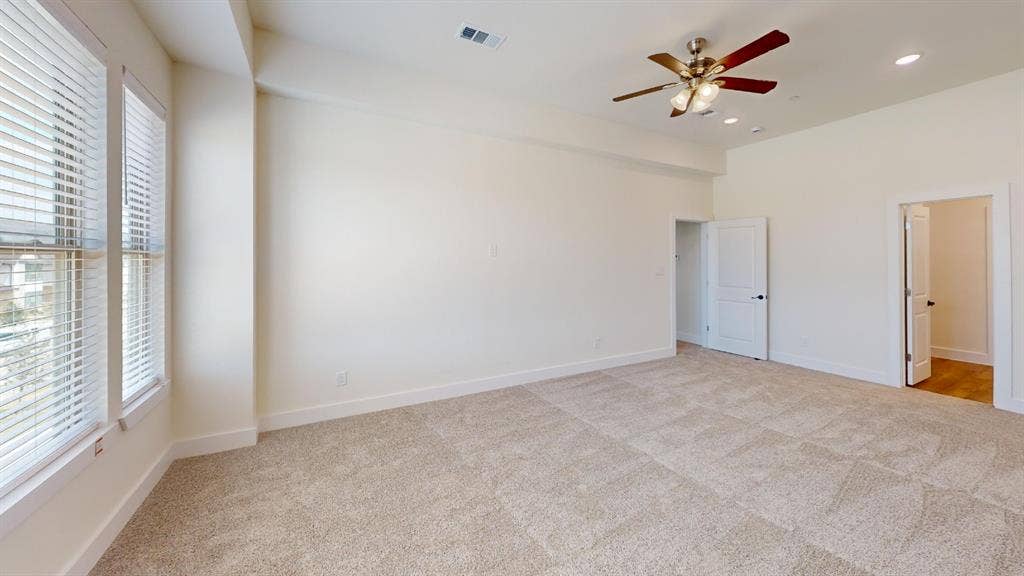 373 Buck Ridge Drive, Frisco, TX 75068 Recessed lighting, ceiling fan, neutral carpeting, multiple windows with blinds, and white doors