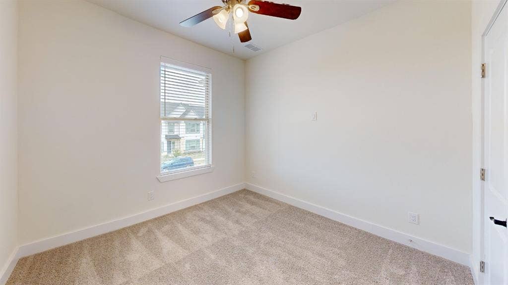373 Buck Ridge Drive, Frisco, TX 75068 Neutral wall tones, carpeted flooring, a window with blinds, a ceiling fan, and a white paneled door
