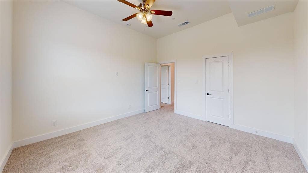 373 Buck Ridge Drive, Frisco, TX 75068 Vaulted ceiling, ceiling fan, neutral wall paint, white trim, and carpeted flooring