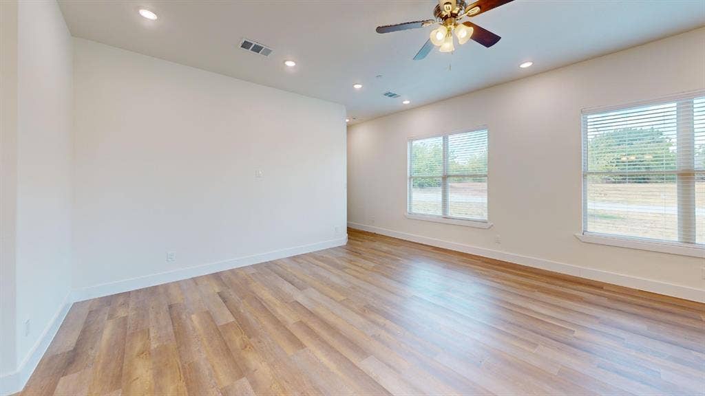 373 Buck Ridge Drive, Frisco, TX 75068 Recessed lighting, wood-finish flooring, and two windows with blinds