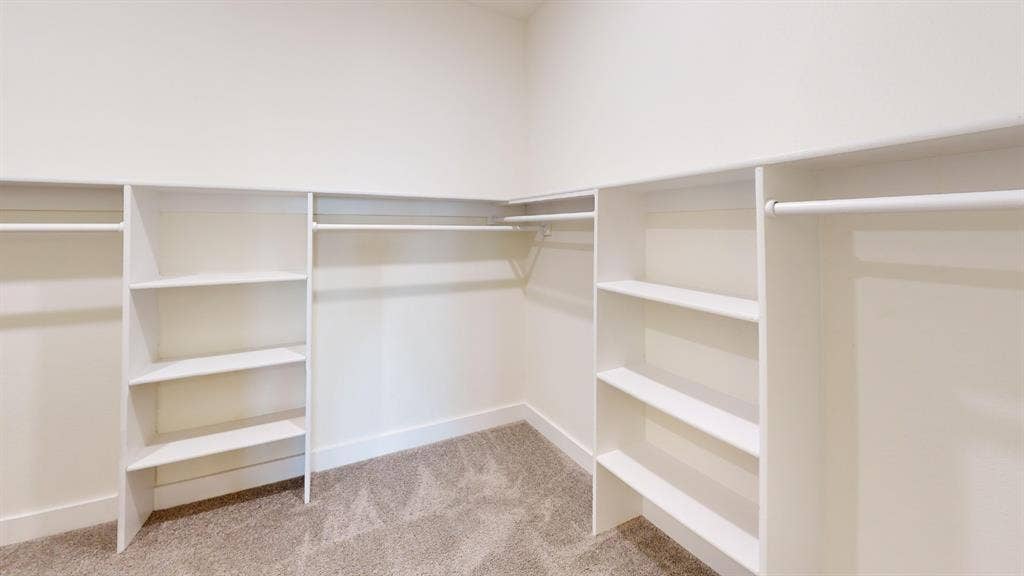 373 Buck Ridge Drive, Frisco, TX 75068 Built-in closet organization system featuring white shelving and hanging rods