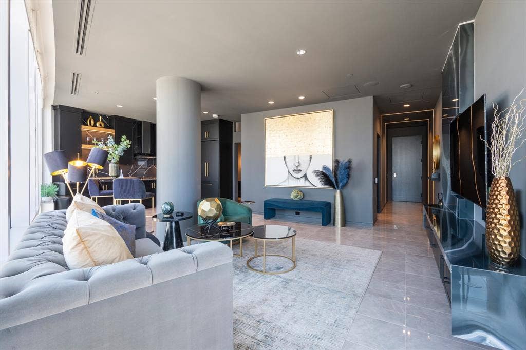 Recessed lighting throughout, expansive window line, sleek built-in cabinetry, and tile flooring