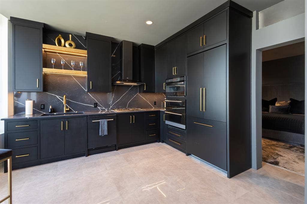 Integrated black cabinetry with gold-tone hardware