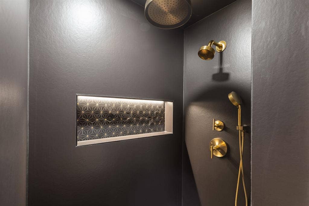 Integrated shower niche with geometric tile and accent lighting