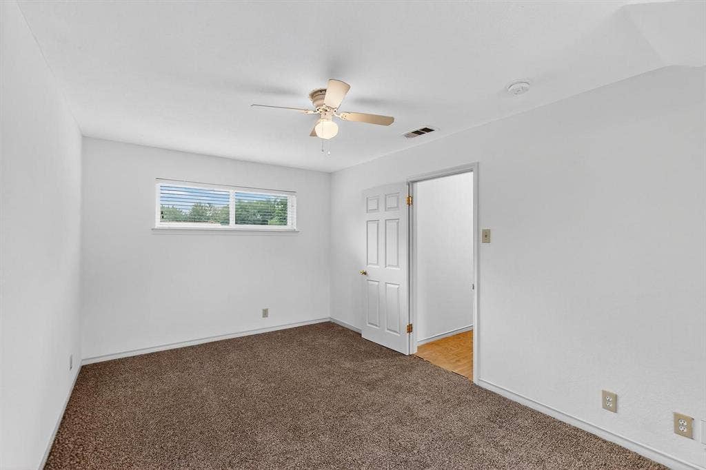 2927 Selma Lane, Farmers Branch, TX 75234 Unfurnished bedroom featuring carpet floors and ceiling fan