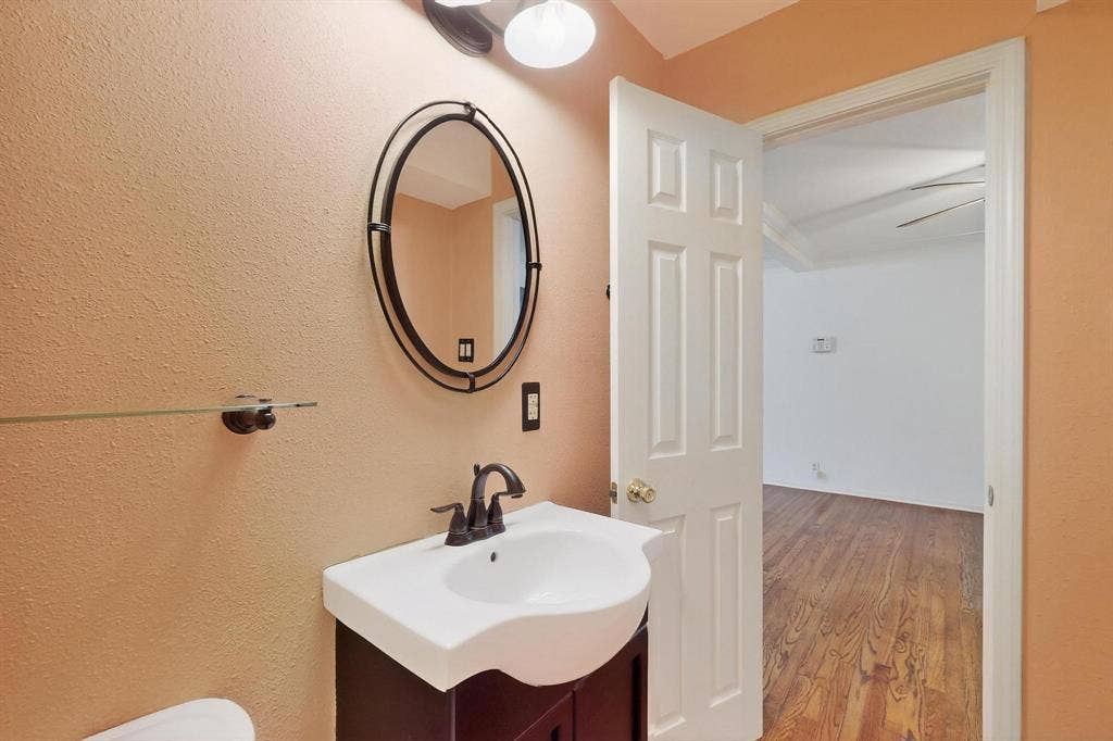 2927 Selma Lane, Farmers Branch, TX 75234 Bathroom with vanity and wood finished floors