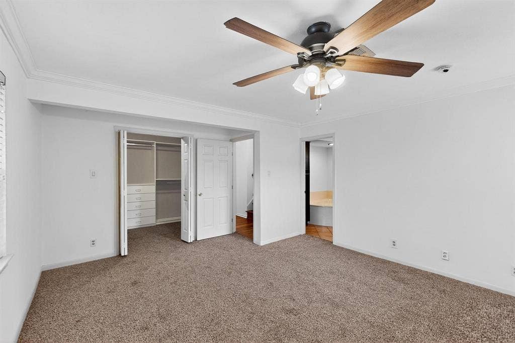 2927 Selma Lane, Farmers Branch, TX 75234 Unfurnished bedroom featuring carpet, crown molding, a closet, and ceiling fan
