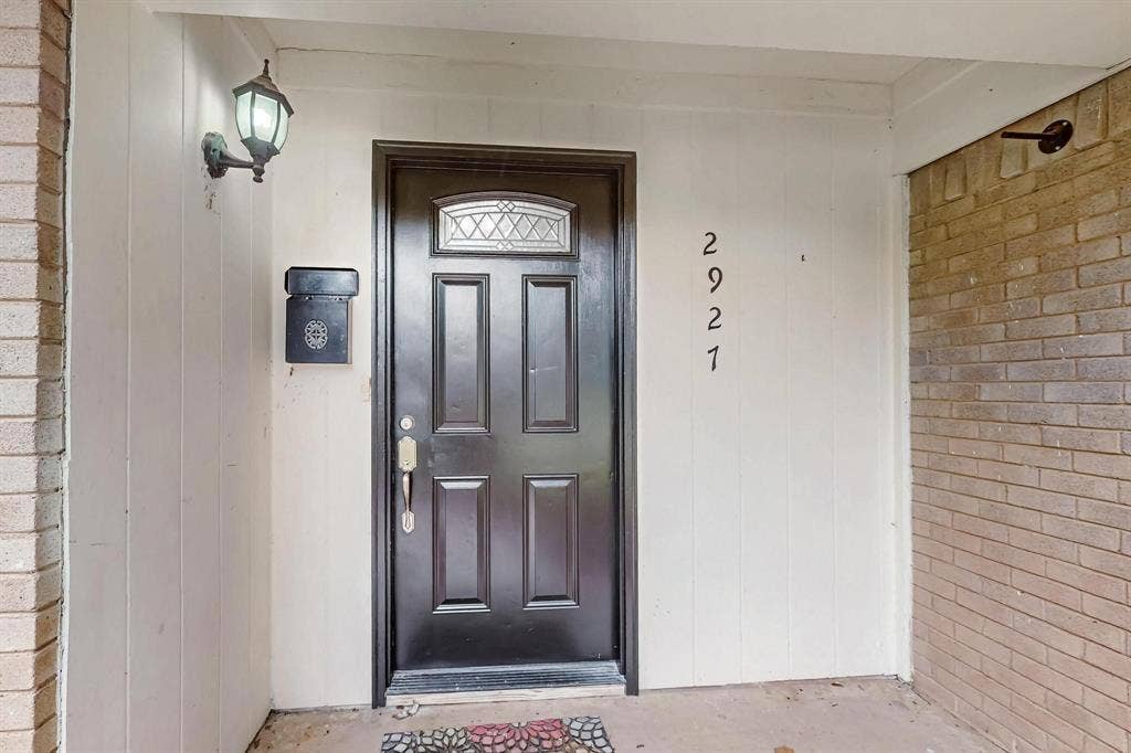 2927 Selma Lane, Farmers Branch, TX 75234 View of exterior entry featuring brick siding