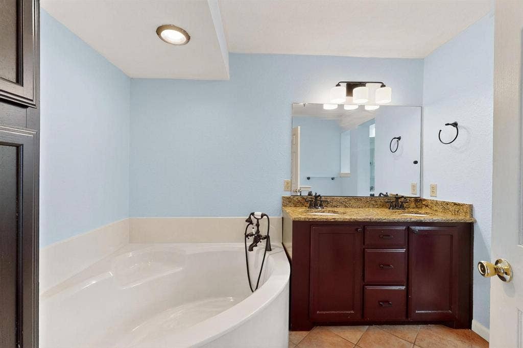 2927 Selma Lane, Farmers Branch, TX 75234 Full bath featuring tile patterned floors, a garden tub, and double vanity