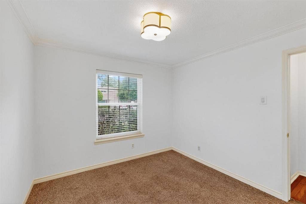 2927 Selma Lane, Farmers Branch, TX 75234 Carpeted empty room featuring crown molding and baseboards
