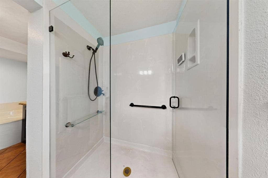 2927 Selma Lane, Farmers Branch, TX 75234 Bathroom with a shower stall and tile patterned flooring