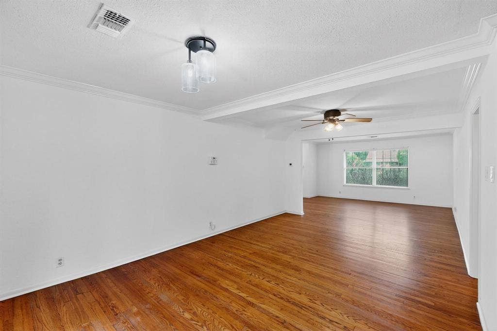 2927 Selma Lane, Farmers Branch, TX 75234 Empty room with wood finished floors, a textured ceiling, a ceiling fan, and crown molding