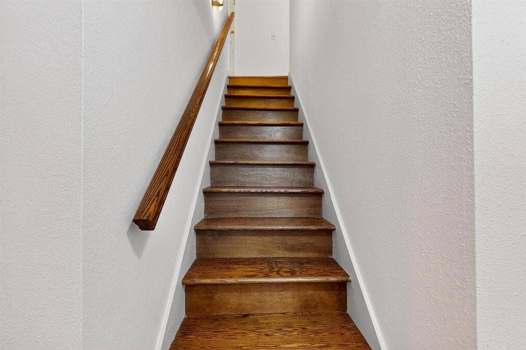 2927 Selma Lane, Farmers Branch, TX 75234 Stairway featuring wood finished floors and a textured wall