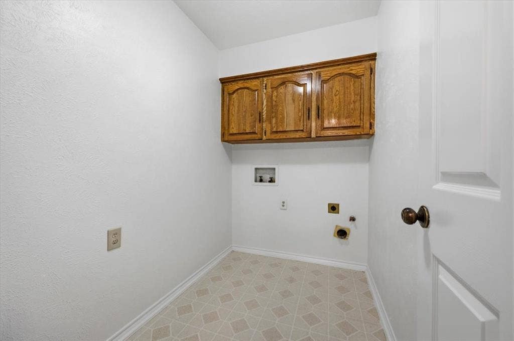 Full size laundry with cabinets for storage right off the garage - gas a electric connection for clothes dryer