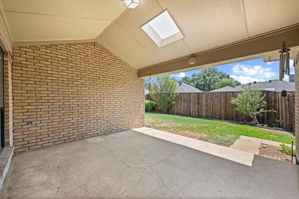 Back covered patio area with skylightwith skylight - large fenced yard on alley with 6ft wood fence