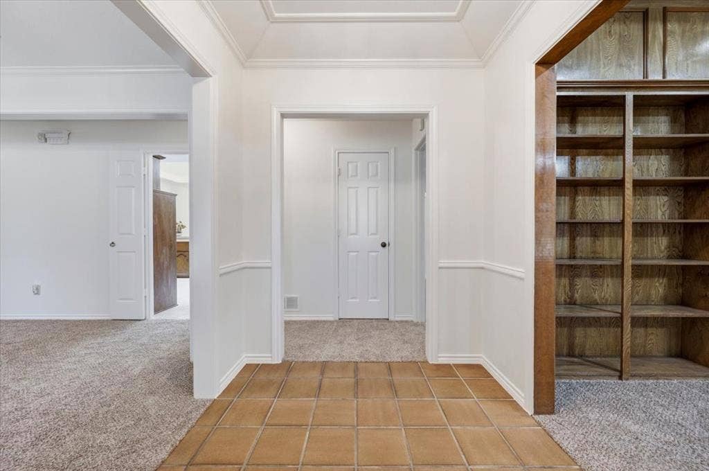 To the right  is the living room that features a full wall of bookshelves