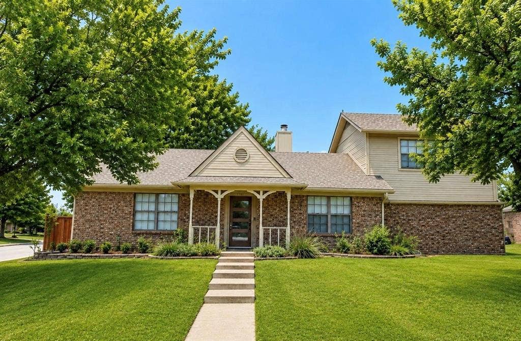 Brick and siding exterior with a covered porch entry
