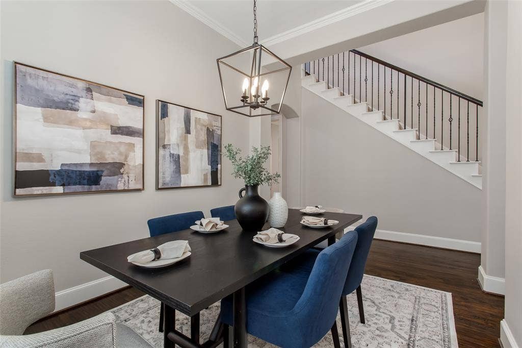 844 Veneto Drive, Allen, TX 75013 Formal dining opens to the two-story foyer, where an arched clerestory window and a new 2026chandelier bring in light. Hand-scraped hardwoods run continuously through both spaces.