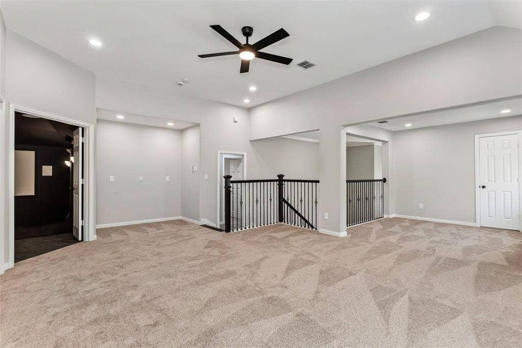 844 Veneto Drive, Allen, TX 75013 Open game room at the top of the stairs with wrought iron railings, recessed lighting, and a new 2026 ceilingfan. Double doors on the left open to the media room.