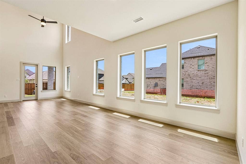 1109 Wheatgrass Mews, Celina, TX 75009 This light filled dining room featuring a wall of windows is the perfect place to host lively dinner parties or cozy family meals.