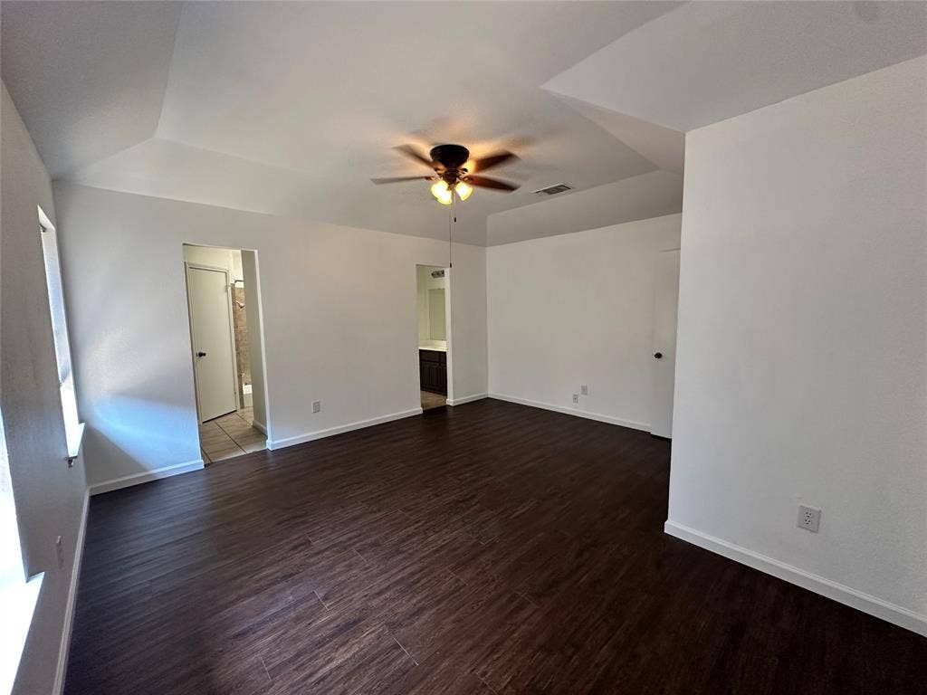 Primary suite with ensuite bath and dual walk-in closets.