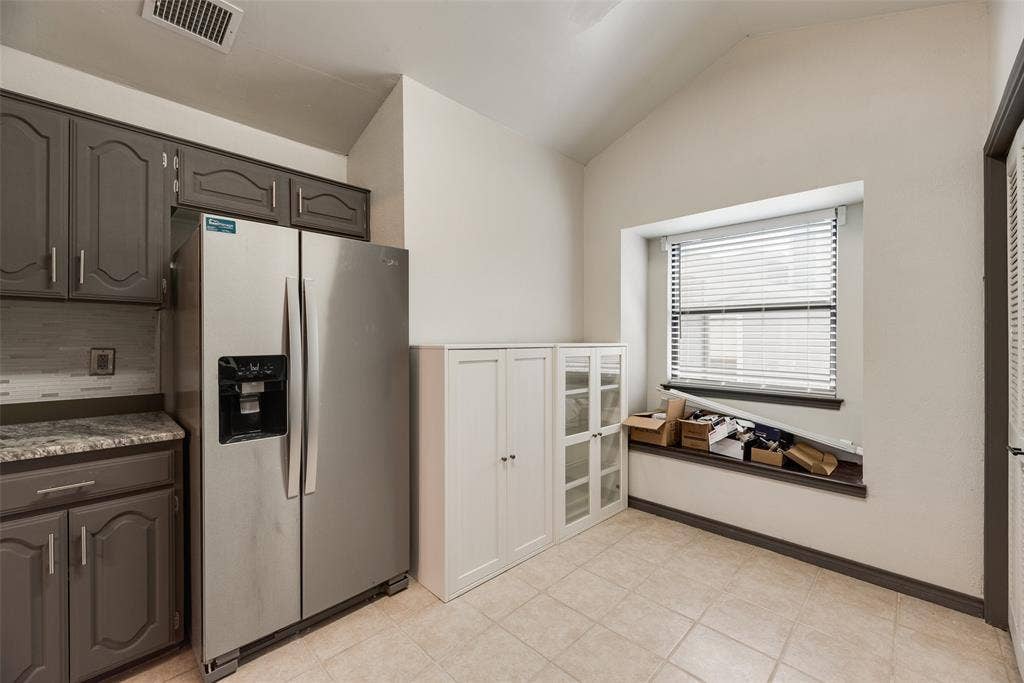 17490 Meandering Way, #202, Dallas, TX 75252 Vaulted ceiling, recessed window, tiled flooring, built-in cabinetry, and gray-painted wood cabinets