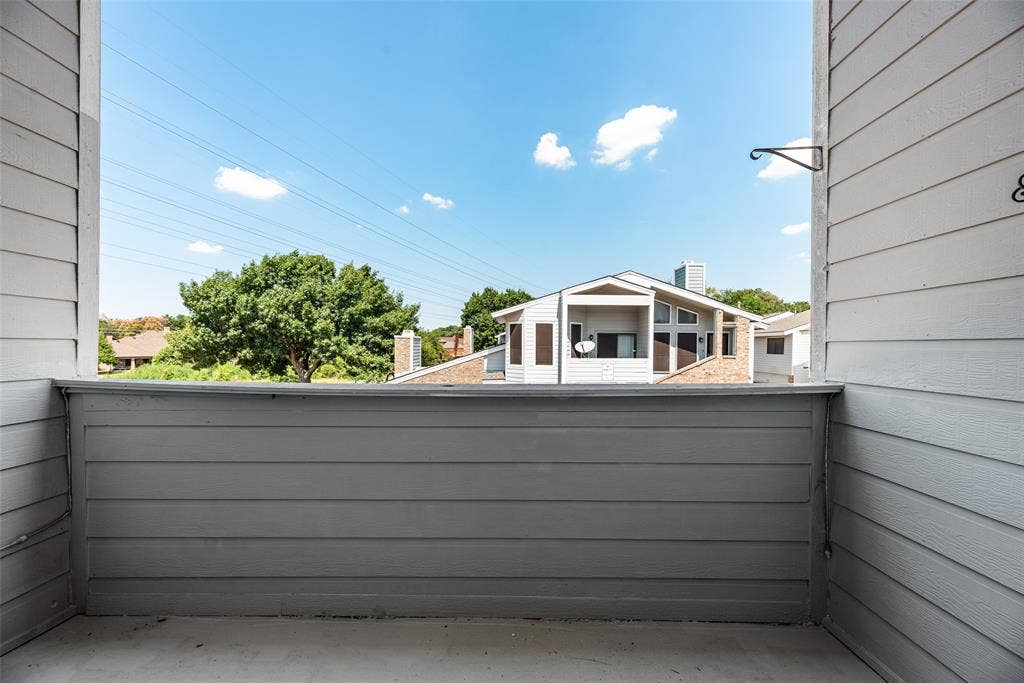 17490 Meandering Way, #202, Dallas, TX 75252 Outdoor balcony featuring horizontal siding and concrete flooring