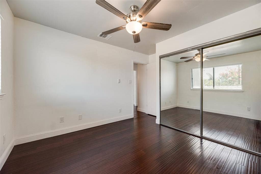 17490 Meandering Way, #202, Dallas, TX 75252 Dark wood-finish flooring, white walls, and a ceiling fan with light fixture