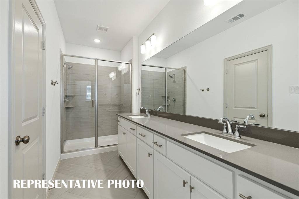 3727 Pierce Lane, Grand Prairie, TX 75052 This fantastic owner's bath features a spacious walk in shower with double vanity offering plenty of space for two! REPRESENTATIVE PHOTO