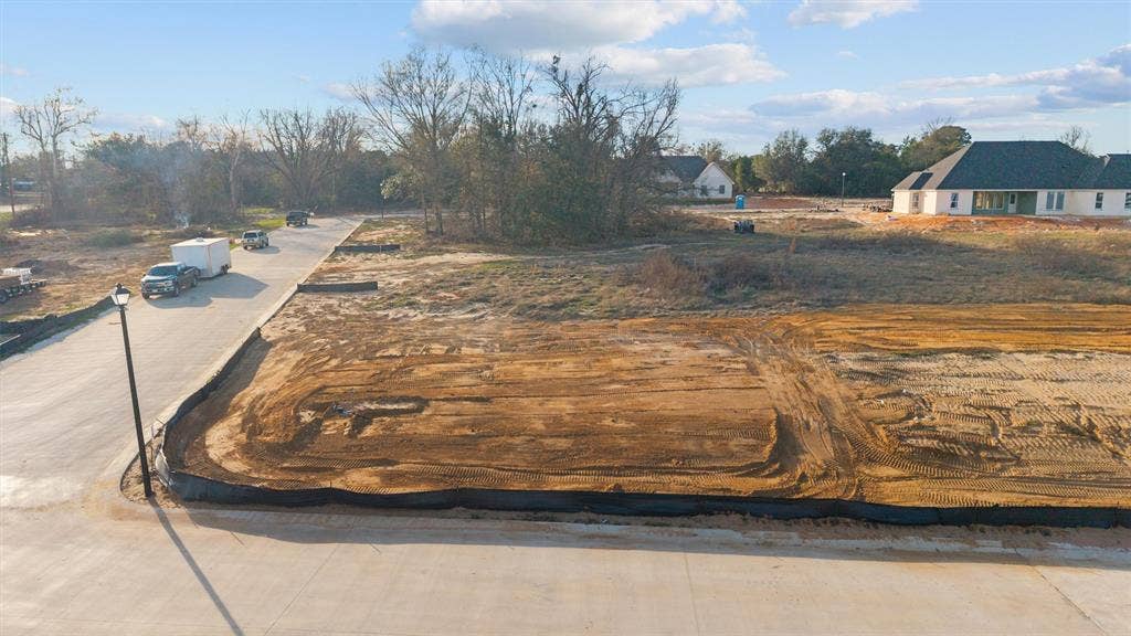 17154 Woodcrest Circle, Lindale, TX 75771 Graded lot with a paved street, sidewalk, and streetlamp