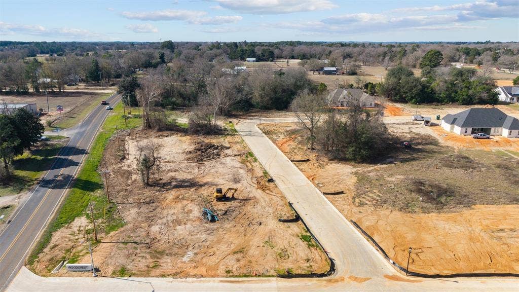 17154 Woodcrest Circle, Lindale, TX 75771 Expansive development site featuring a paved road, established road frontage, and surrounding residential structures