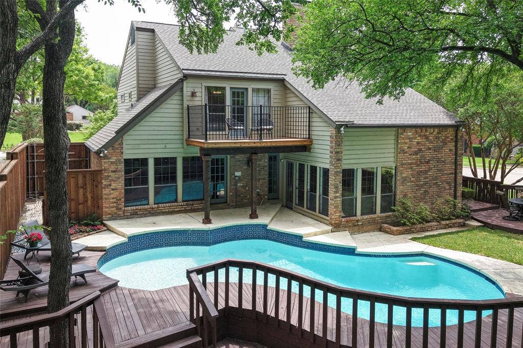 2001 Pebble Beach Court, Richardson, TX 75082 The backyard is the home’s crowning jewel—a serene oasis where a two tier deck and mature shade trees wrap the pool in privacy. Check out that upper deck off the primary bedroom!