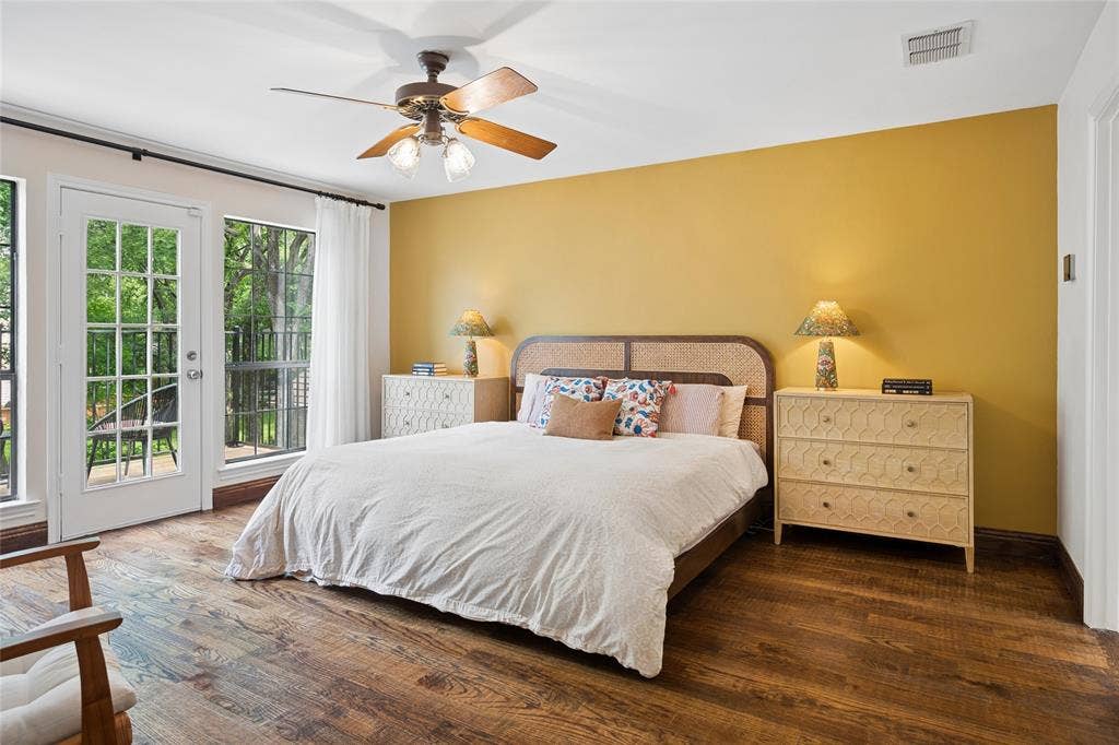 2001 Pebble Beach Court, Richardson, TX 75082 The spacious primary bedroom with hardwood floors upstairs, features a private balcony retreat overlooking the lush backyard, pool, and creek.