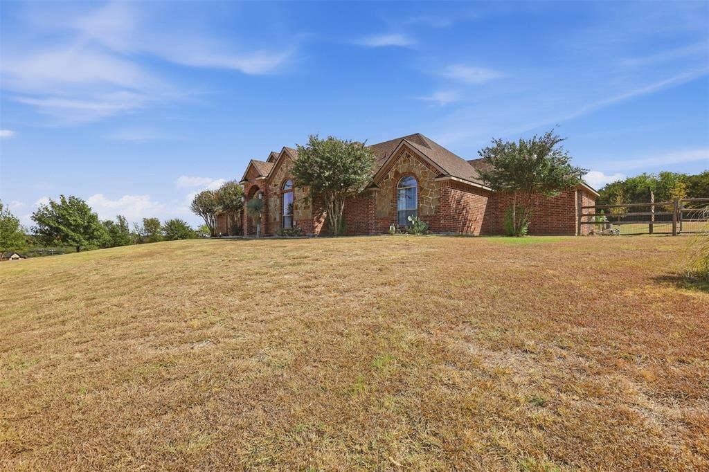 Brick and stone exterior with arched windows and a gabled roof