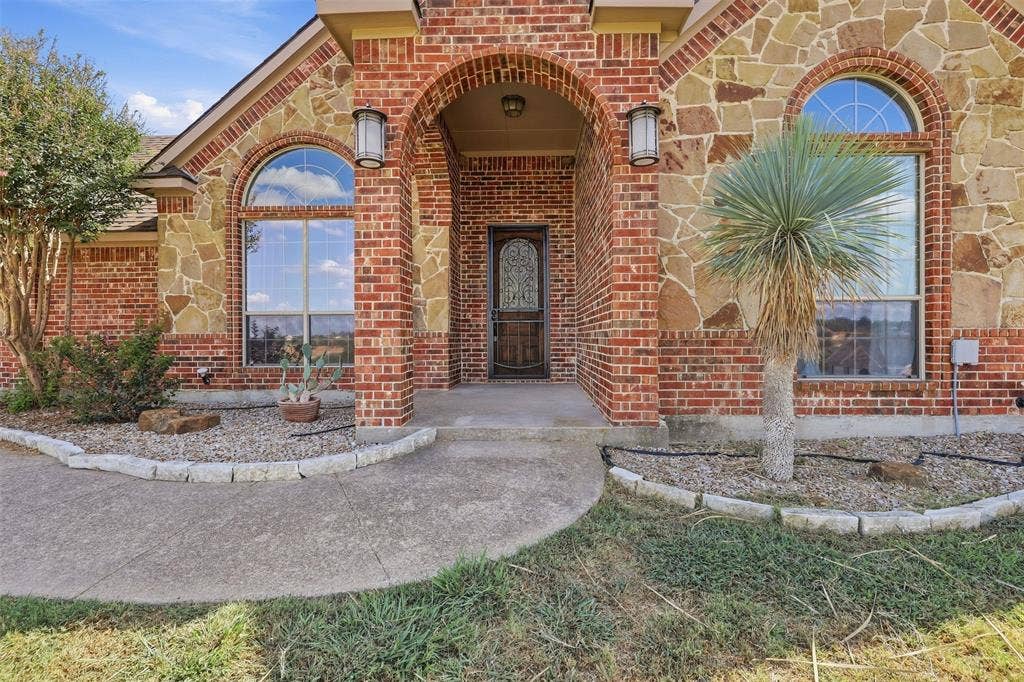Brick and stone exterior with arched entry