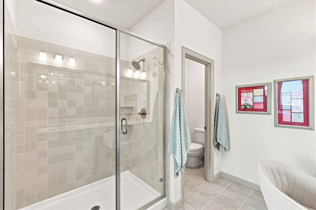 612 4th Street, Argyle, TX 76226 Oversized subway tile surround shower with water closet for privacy.