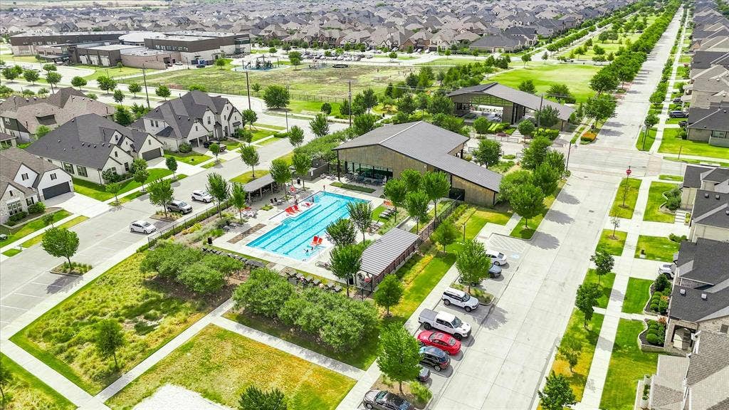 612 4th Street, Argyle, TX 76226 Community pool with adjacent recreational building, surrounded by multiple residential properties and green spaces