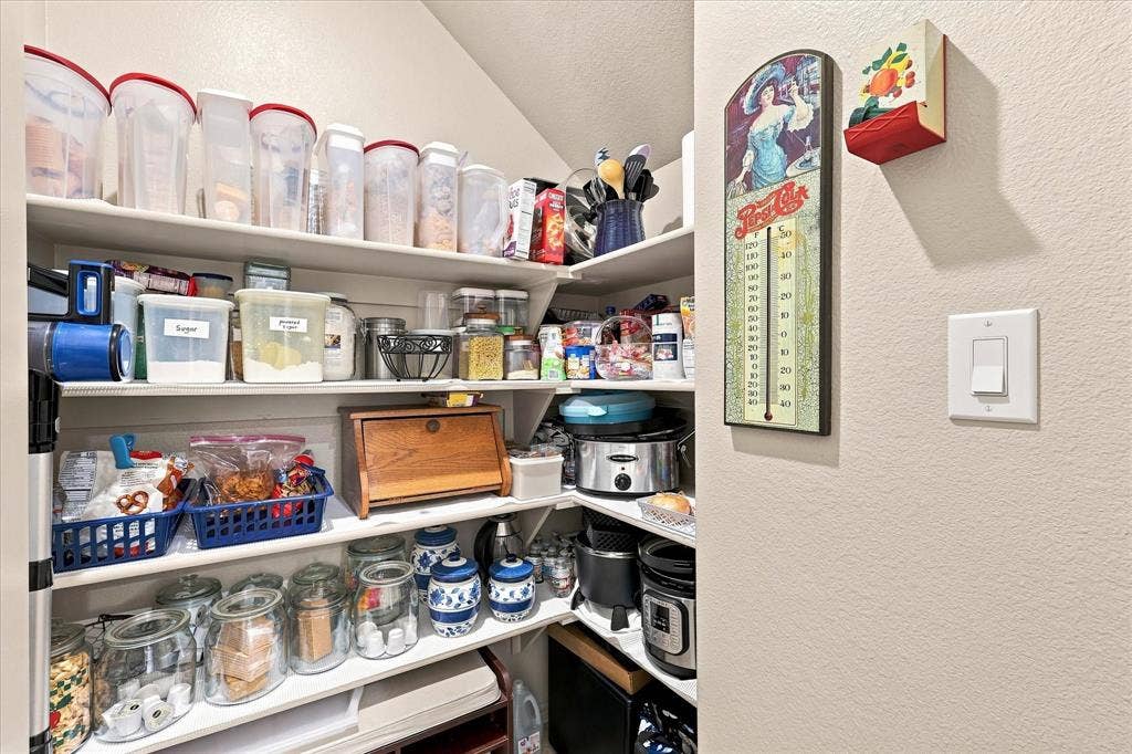 612 4th Street, Argyle, TX 76226 Large corner walk-in pantry featuring multiple built-in shelves