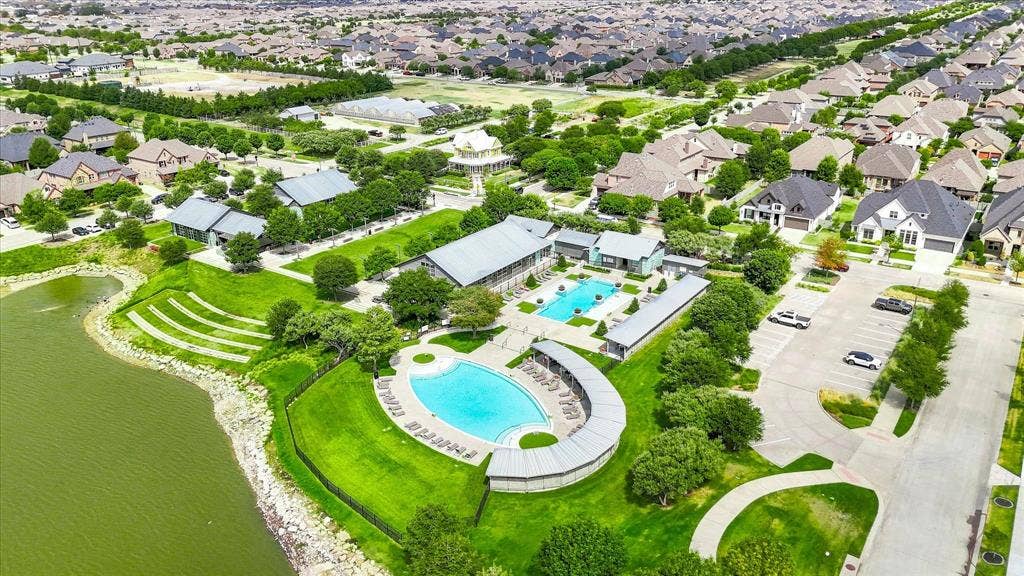 612 4th Street, Argyle, TX 76226 Expansive community featuring multiple residential properties, a large central swimming pool, a second swimming pool, and a recreational building