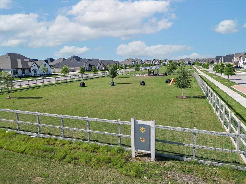612 4th Street, Argyle, TX 76226 Expansive green space featuring a fenced dog park, covered pavilion, and walking paths, surrounded by residential properties