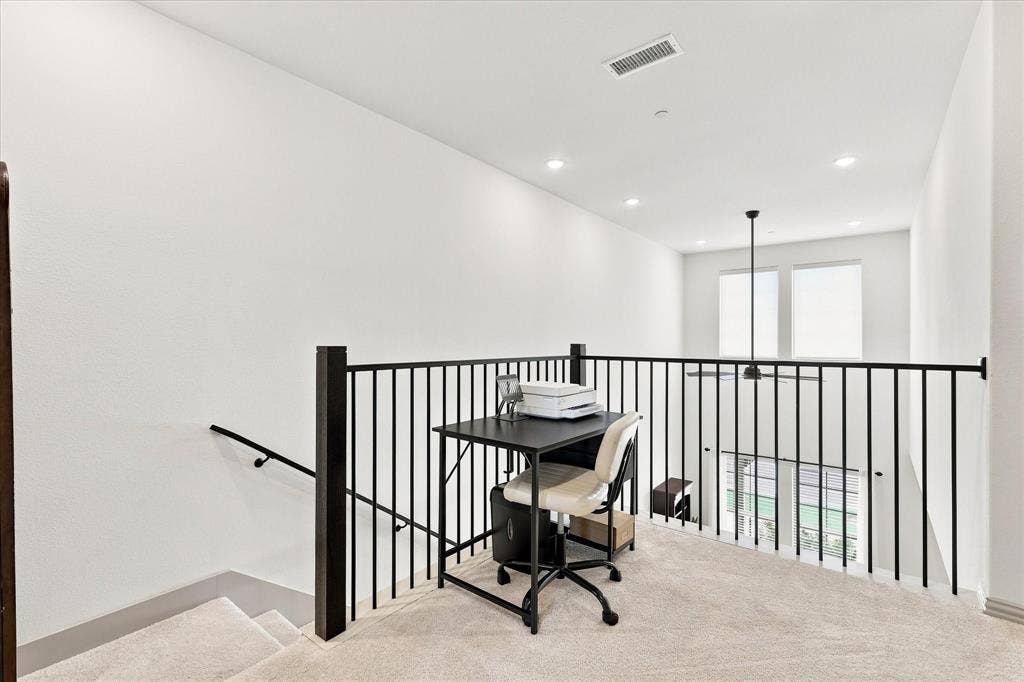 612 4th Street, Argyle, TX 76226 Open loft area featuring carpet flooring, dark metal railings, and recessed lighting. Makes a perfect office or reading area.