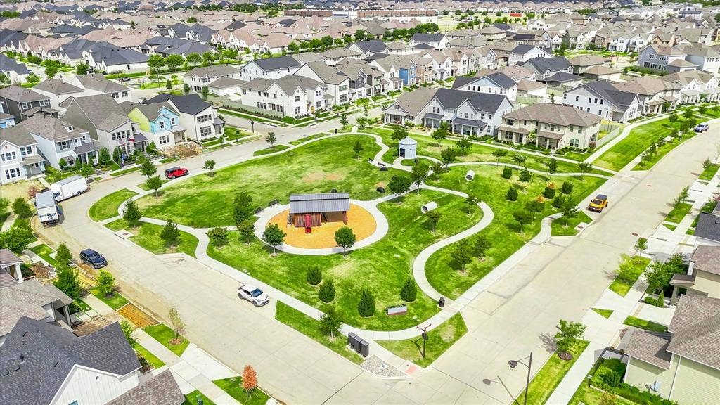 612 4th Street, Argyle, TX 76226 One of many expansive community parks featuring a playground, walking paths, and mature landscaping, surrounded by residential homes